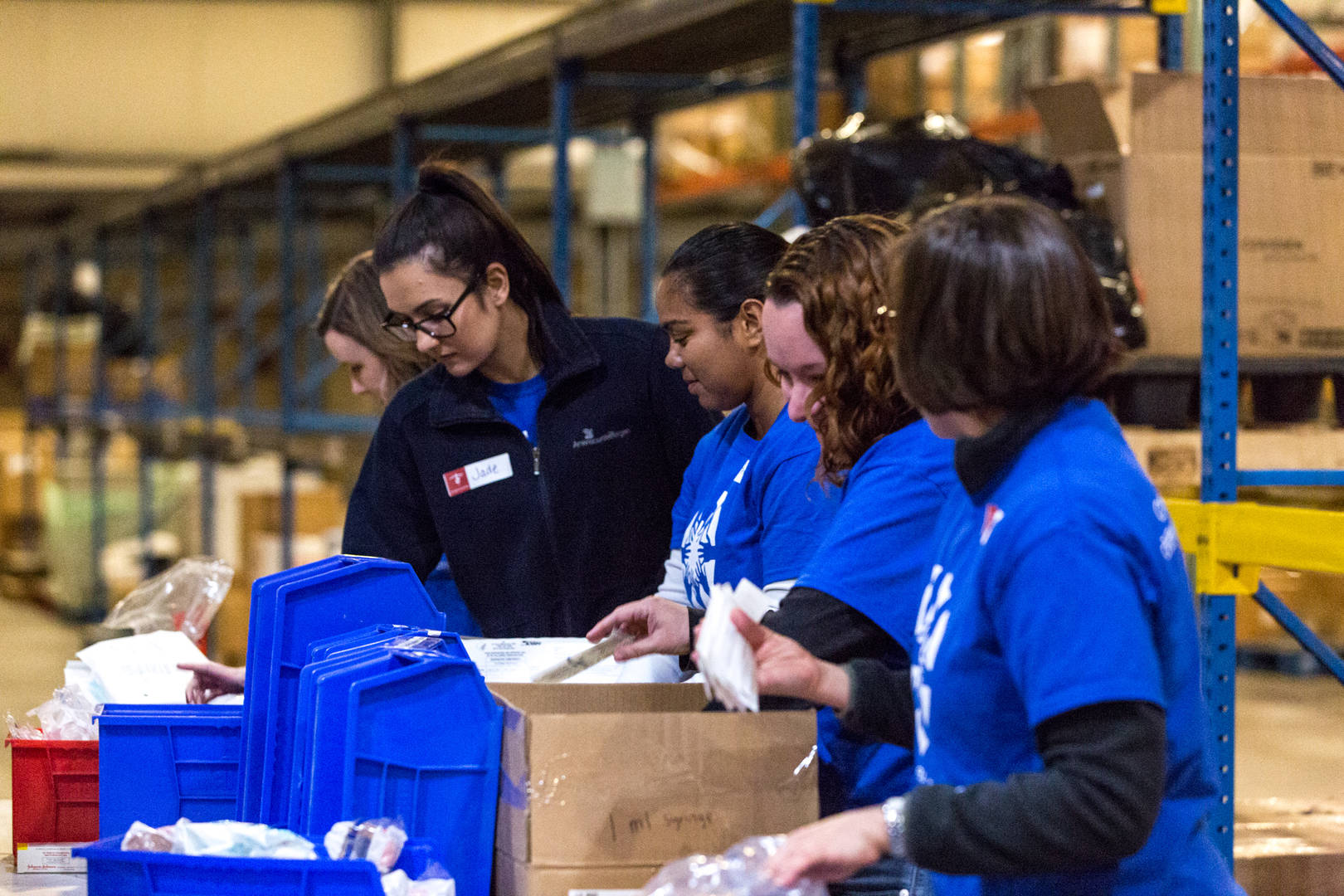 Volunteers from AmerisourceBergen pack boxes to support Project C.U.R.E.