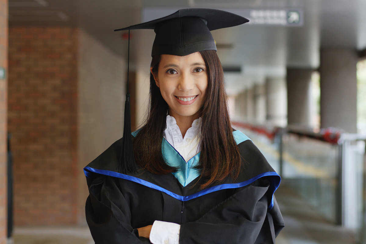A young woman in a graduation cap and gown