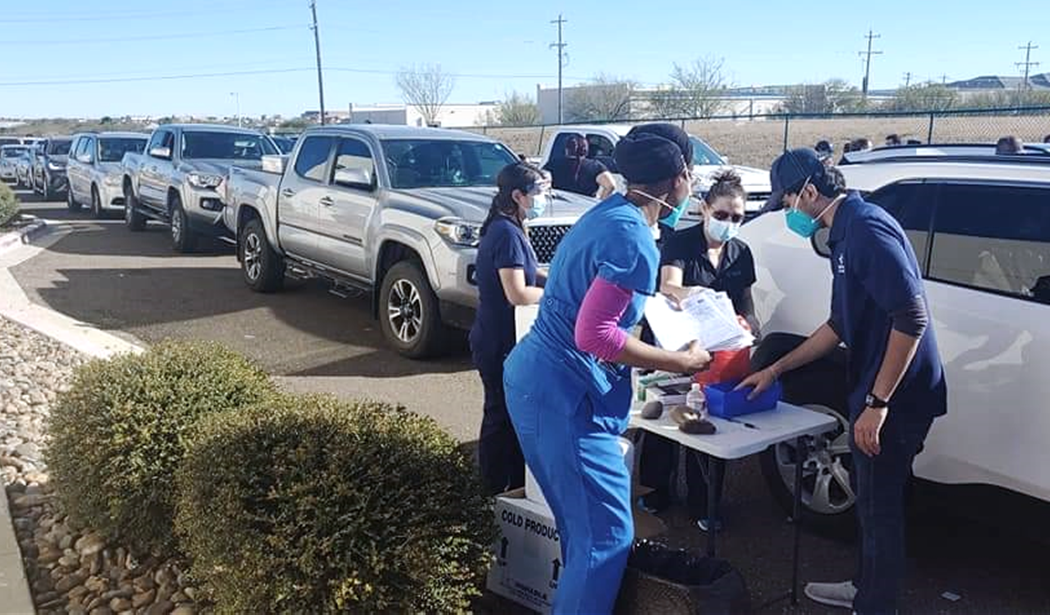 An independent pharmacy team administering COVID-19 vaccinations via drive-thru