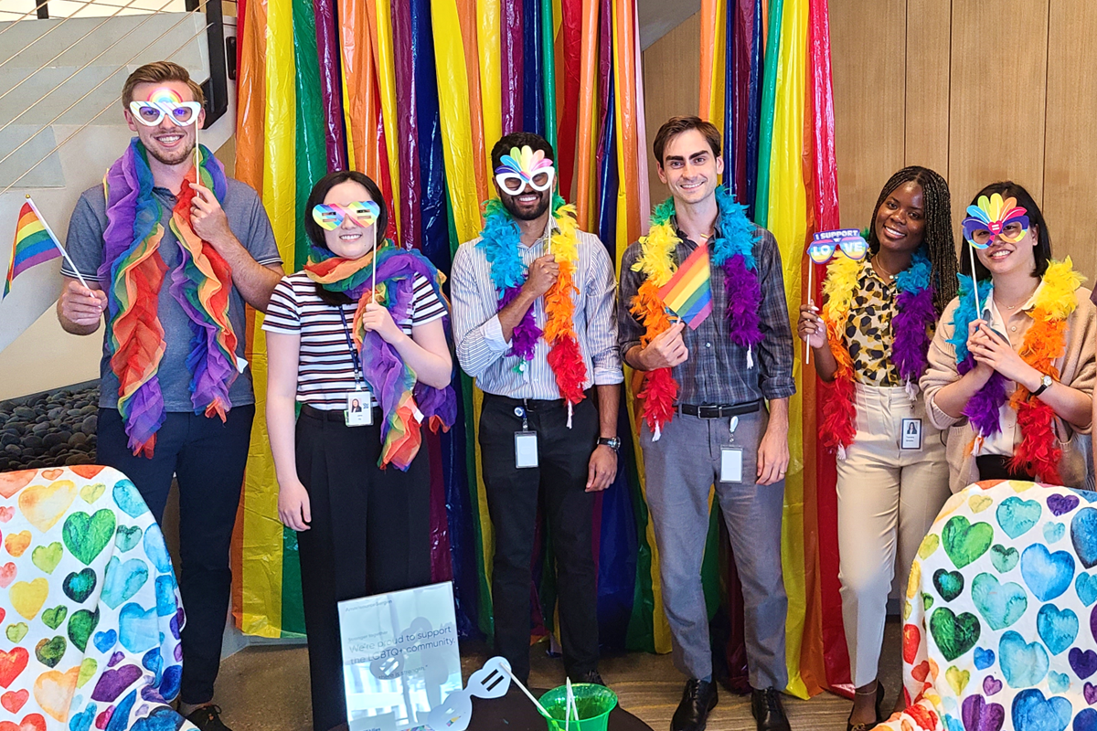 A diverse group of coworkers celebrating Pride Month 2023 in the Carrollton, Texas office