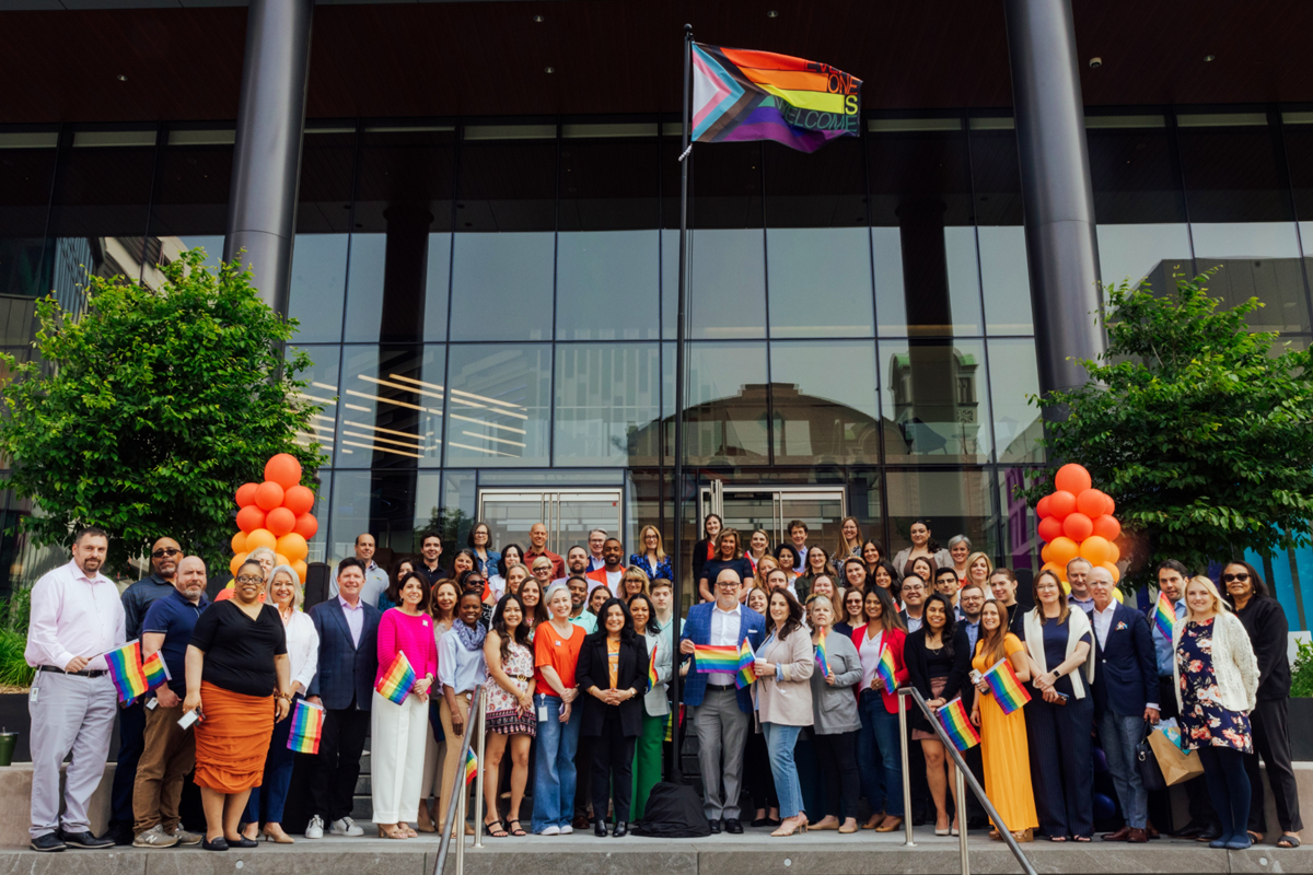 A large group of team members and leaders celebrating Pride Month 2023 on the steps of their Conshohocken, Pennsylvania headquarters