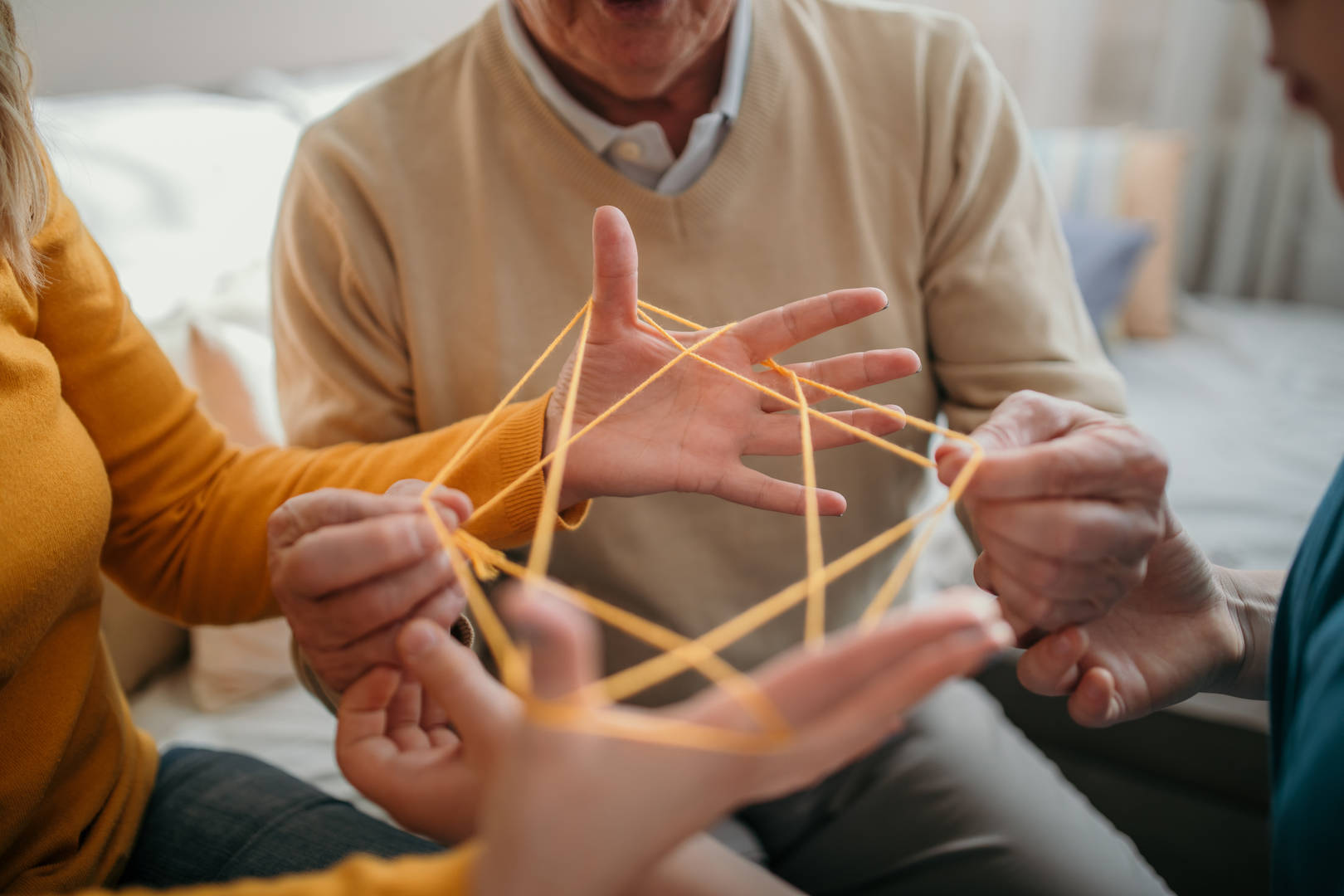 Family plays cat's cradle