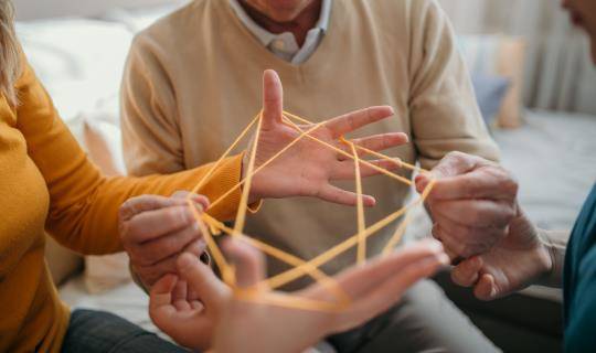 Family plays cat's cradle