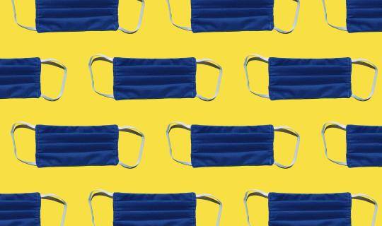 blue face masks on yellow background tiled