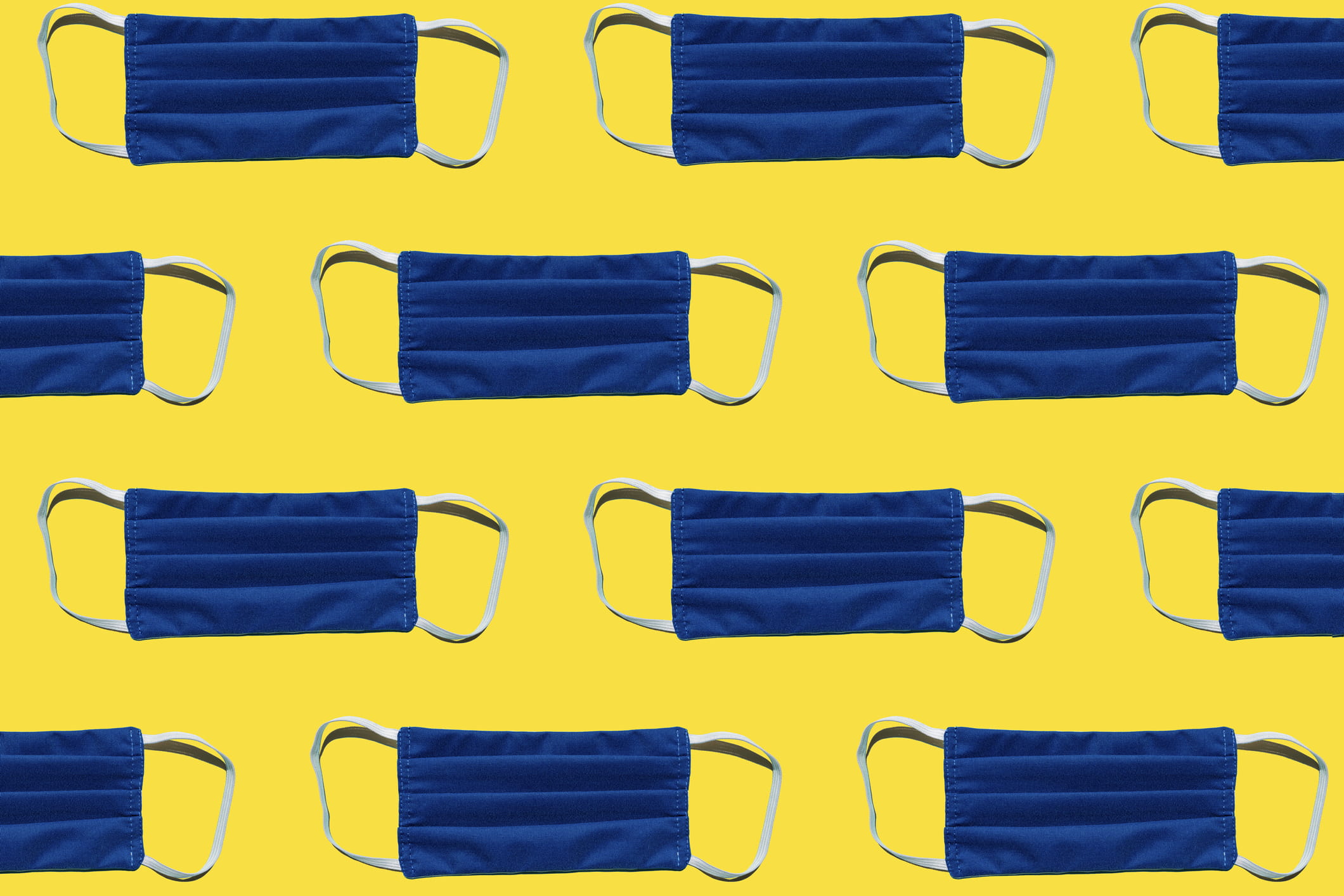blue face masks on yellow background tiled