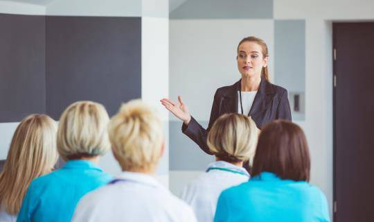 female speaking to medical audience