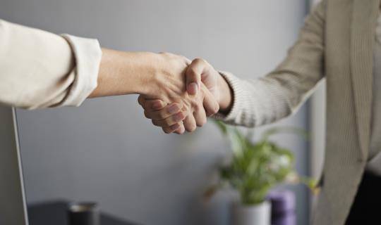 Close-up of two business women shaking hands