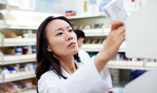 pharmacist female pulling product