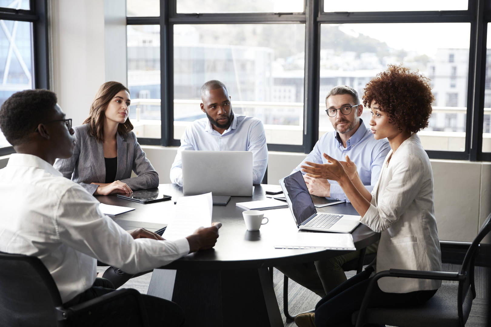 professionals-around-table-laptops