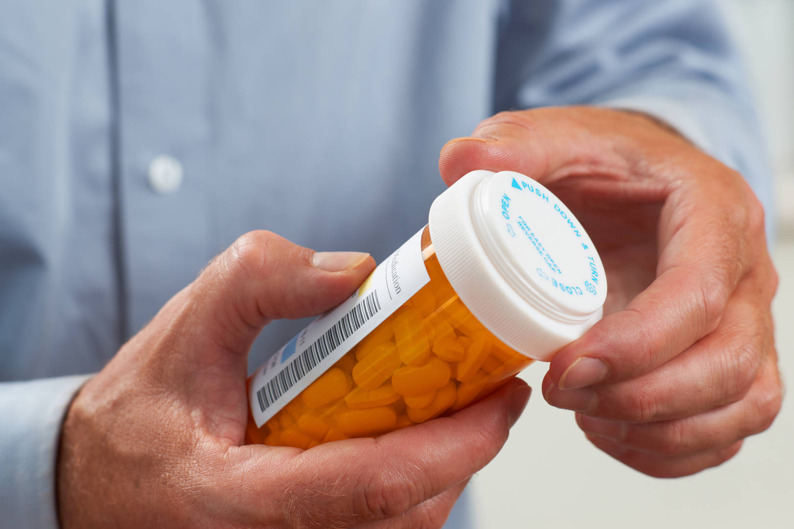 patient holding prescription bottle