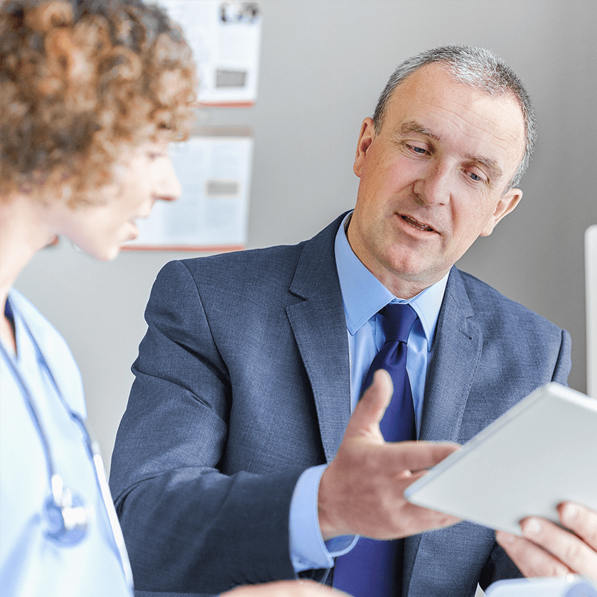 Consultant and doctor with tablet computer