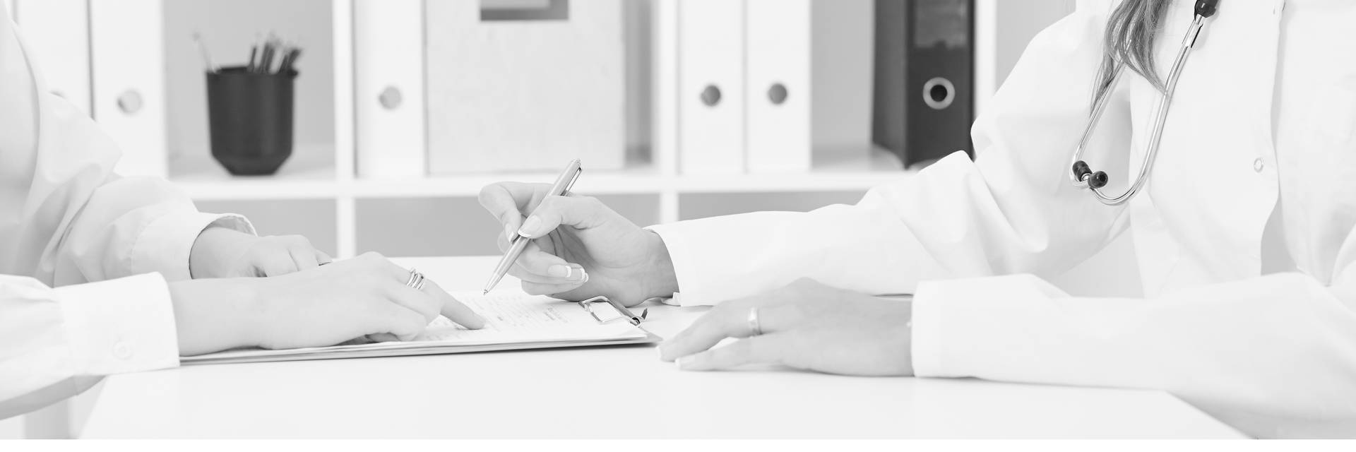 Hands writing on a clipboard