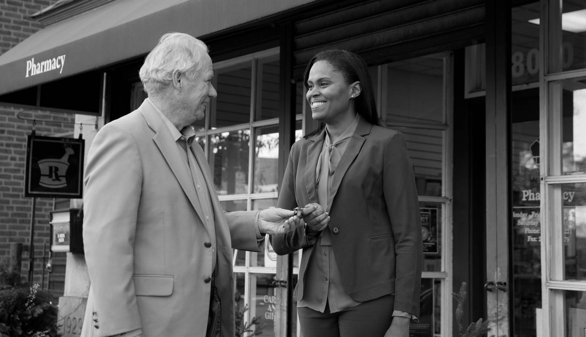 A pharmacy seller hands the keys over to the new owner