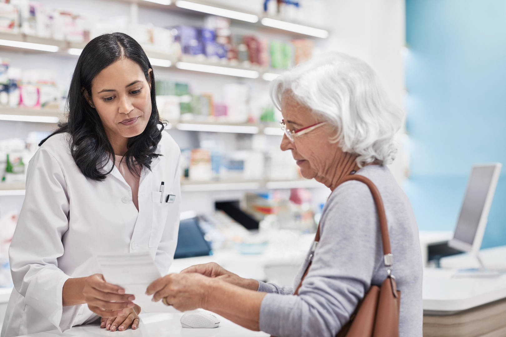 Elderly woman talks to pharmacist