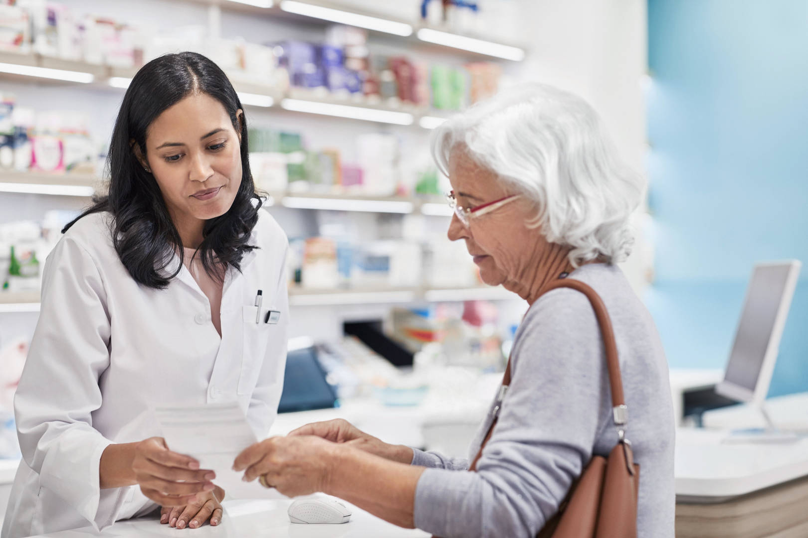 Elderly woman talks to pharmacist
