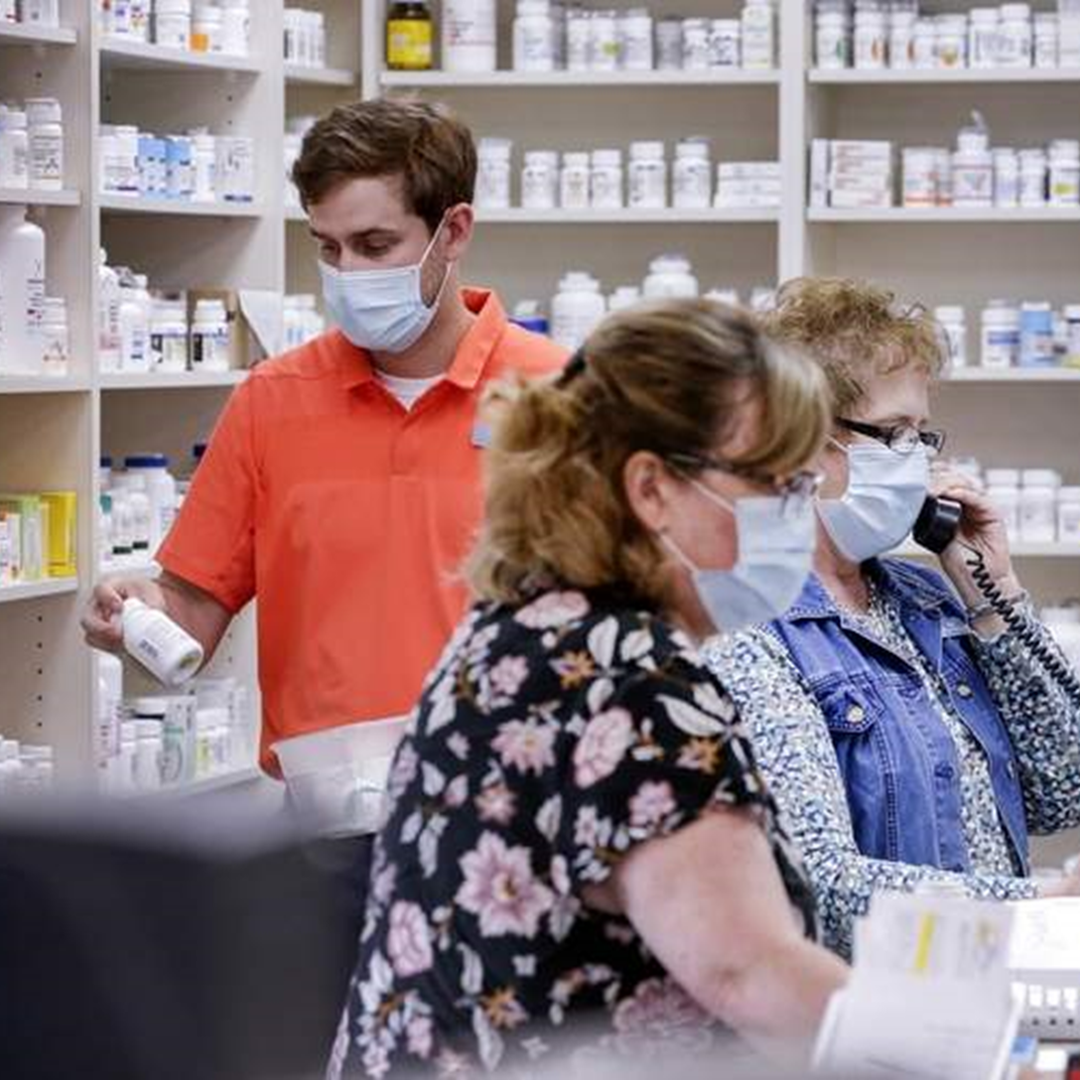 The staff at Clark's Pharmacy wearing face masks behind the counter