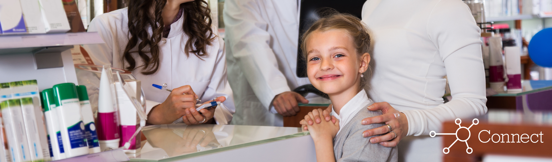 Two pharmacists help a mother and her daughter