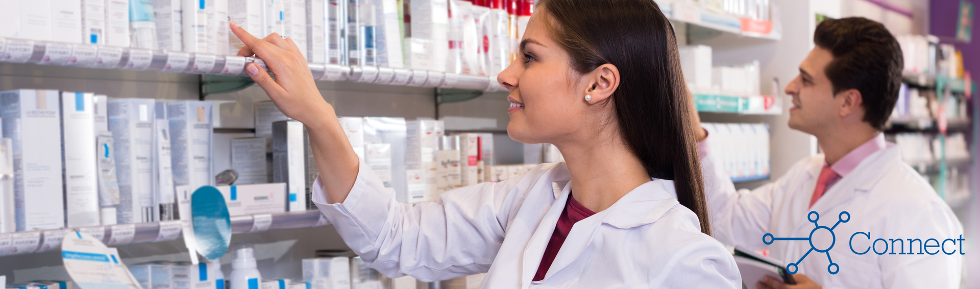 Two pharmacists filling prescriptions in a pharmacy