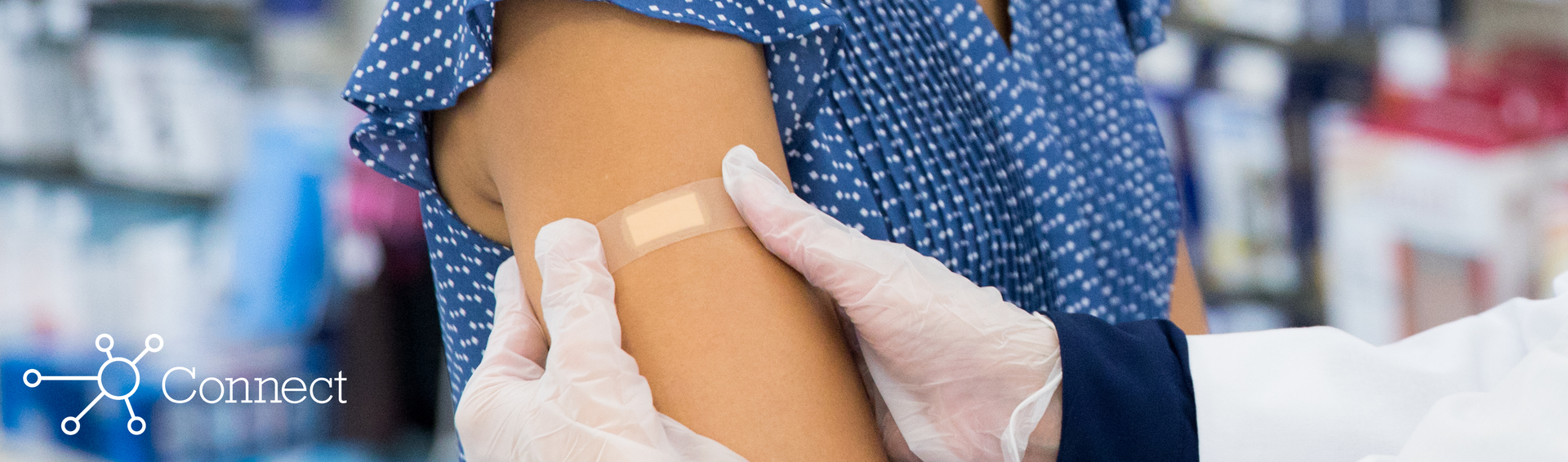 A pharmacist giving a patient a flu shot