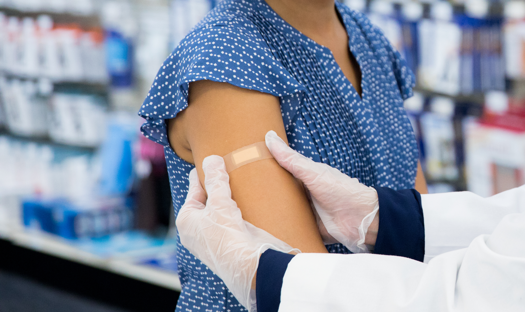 A pharmacist giving a patient a flu shot
