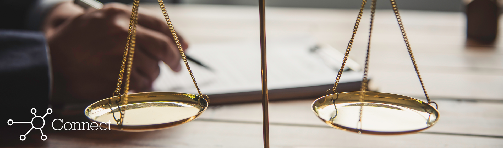 A man writing notes on a notepad behind a scale