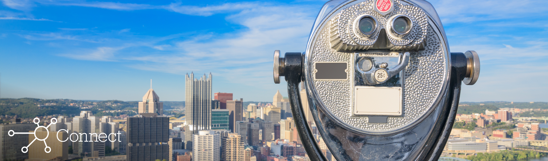 Rooftop binoculars looking out over a city