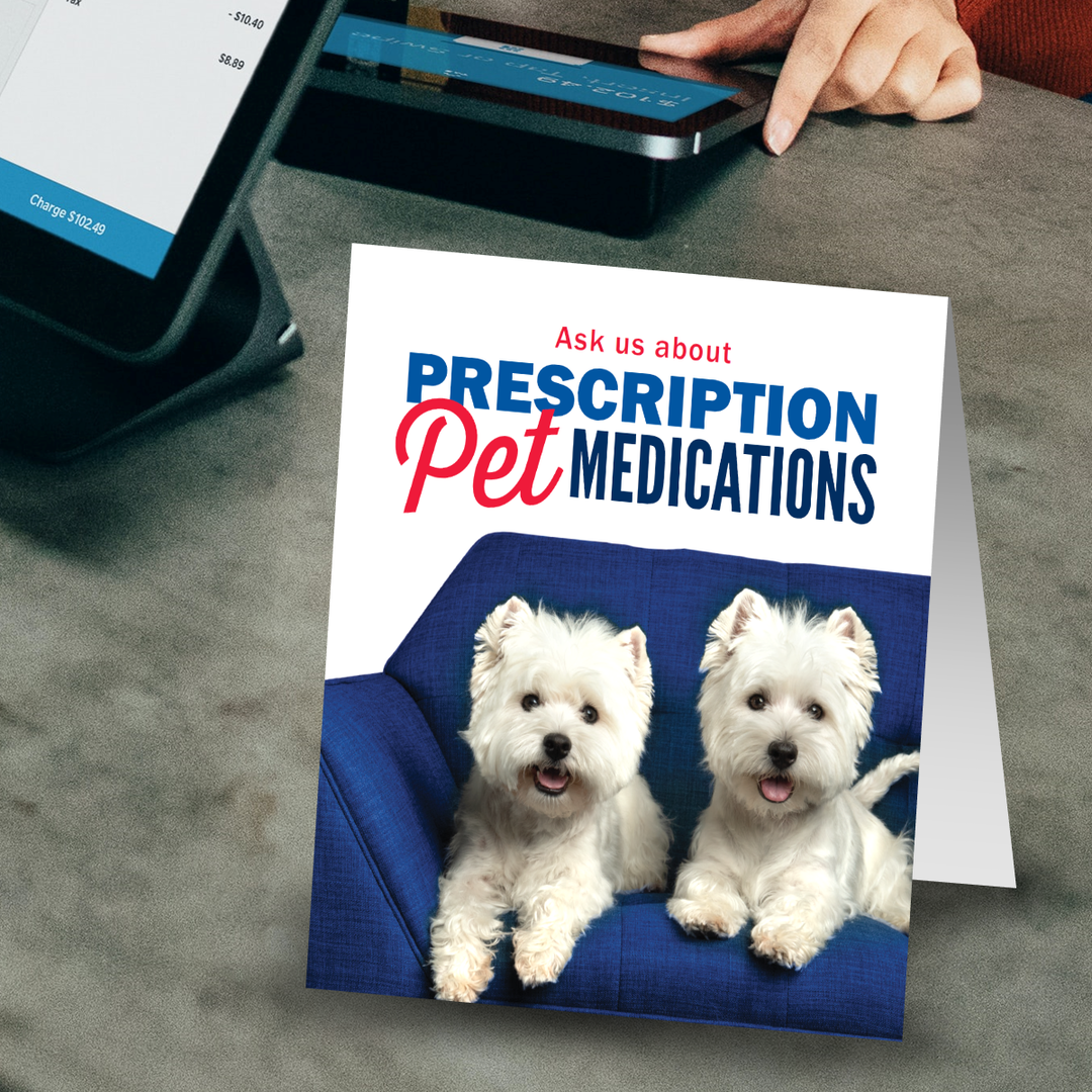A pet health promotional display sitting on a pharmacy counter