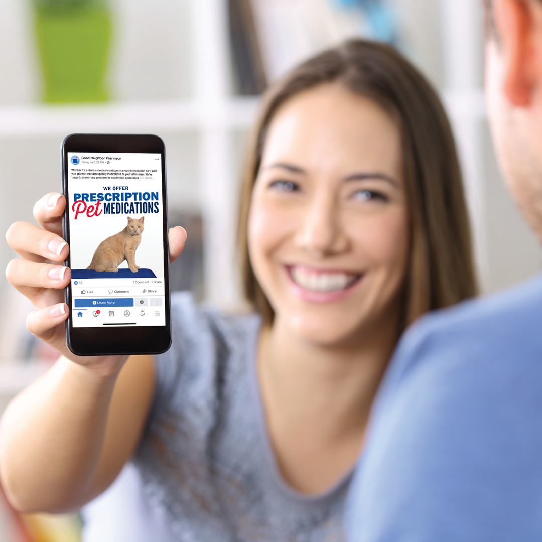A woman showing someone a Facebook post promoting pet health on her phone
