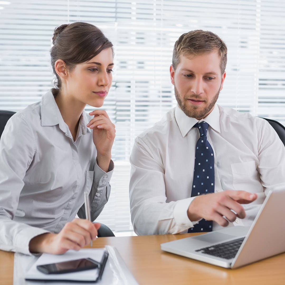 Two people collaborating with a laptop