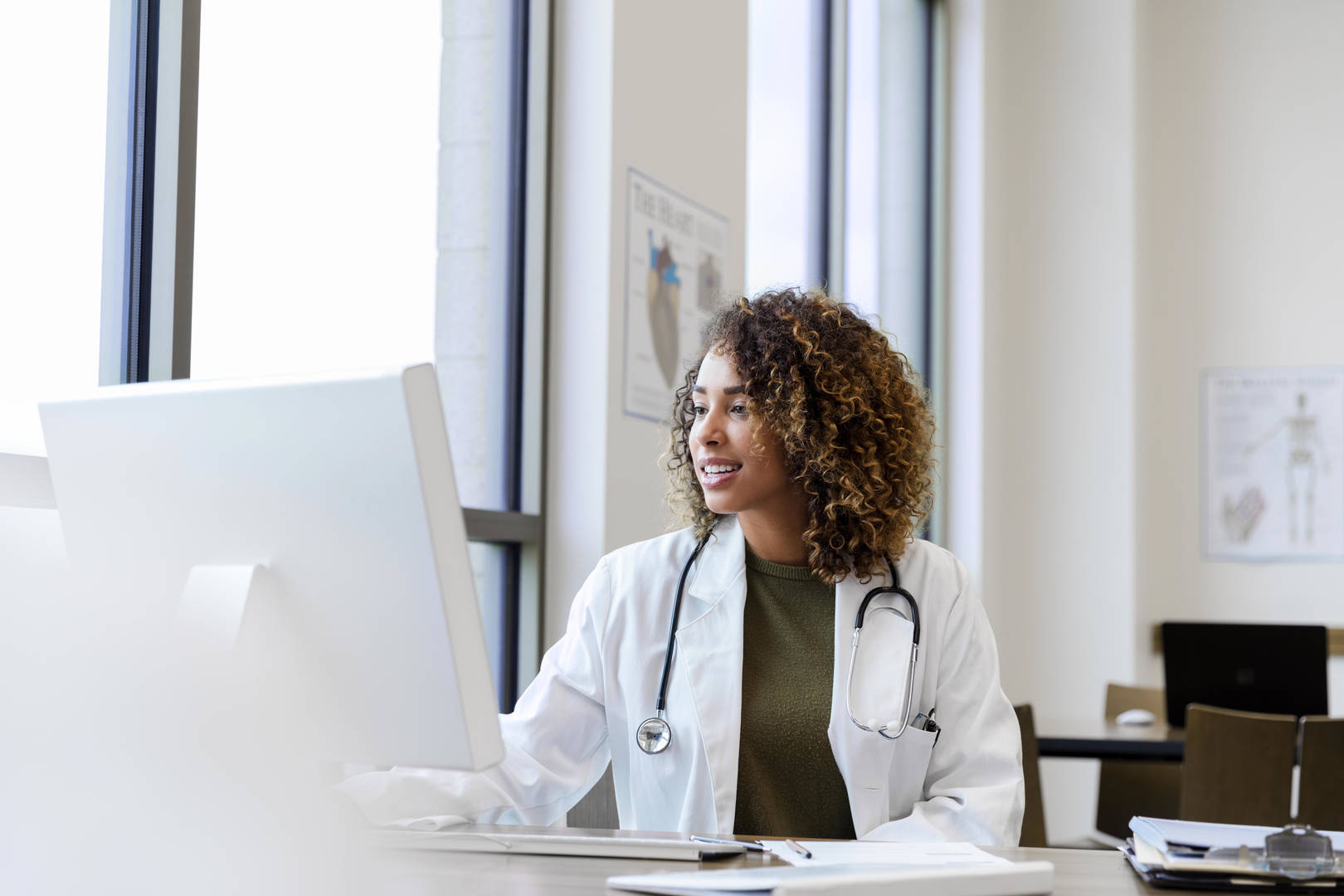 Female doctor at computer in office