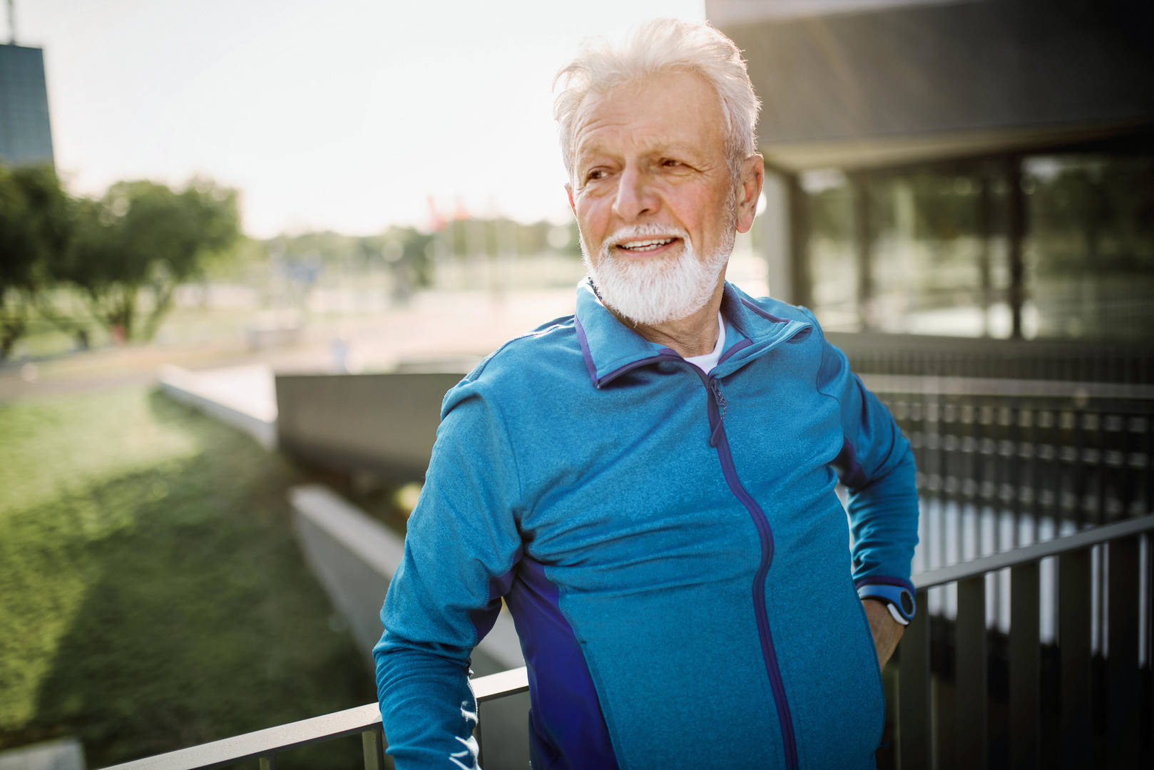 Elderly man smiles outside