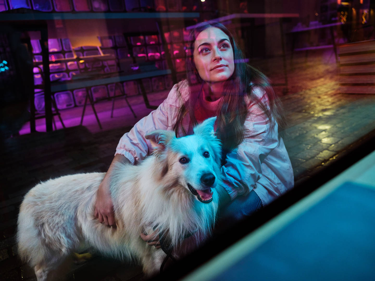 young woman with white dog against artistic background