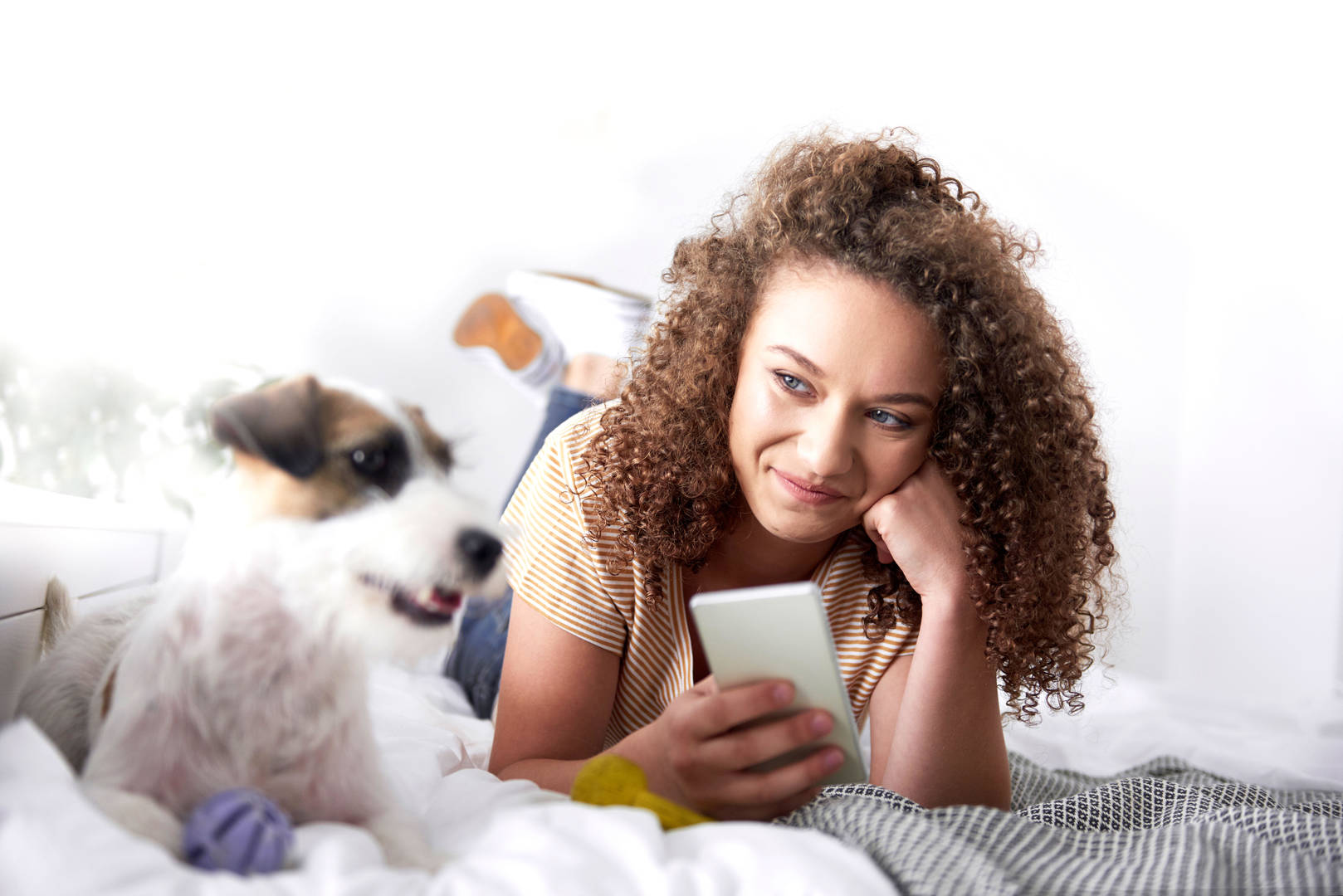 Woman looks at phone with her dog