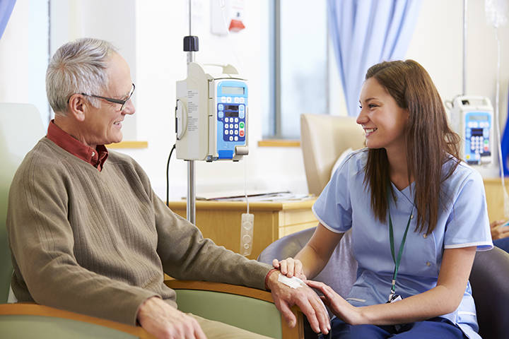 Oncology patient with medic seated