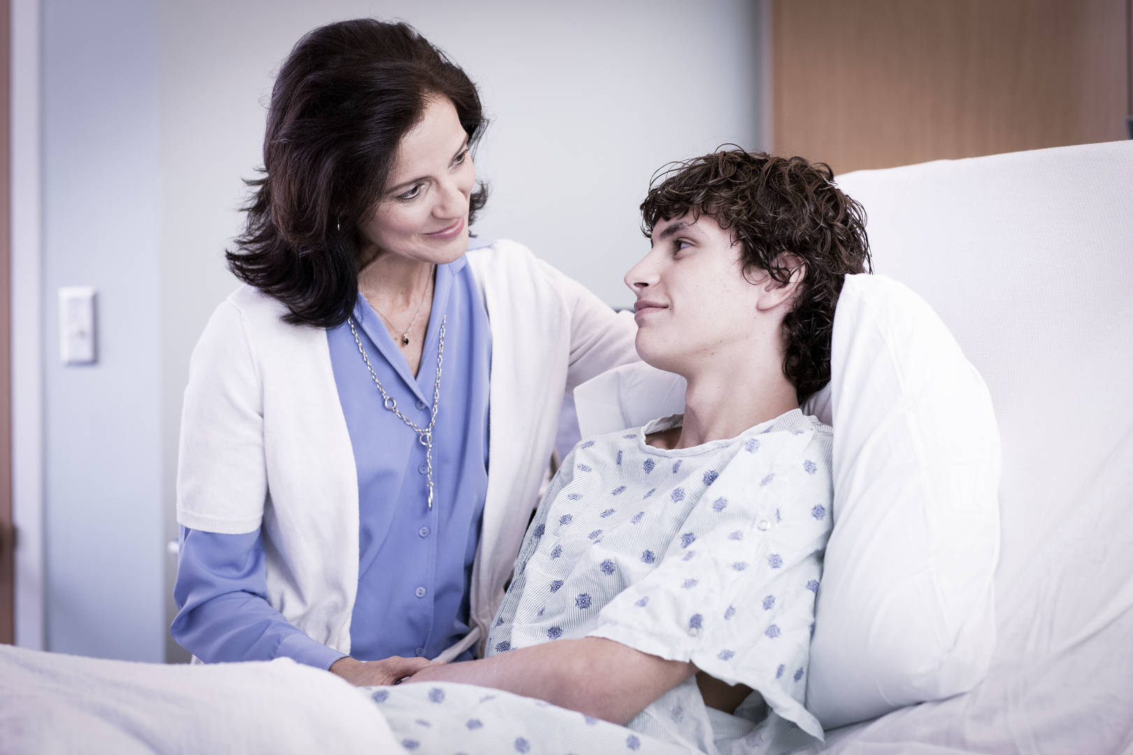Child in a hospital bed receives care.