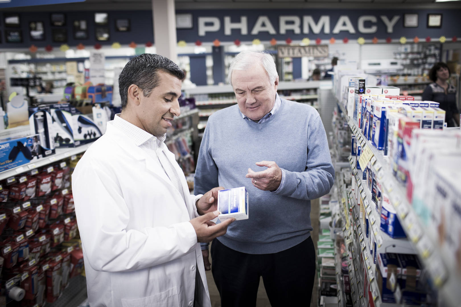 Pharmacist assists patient.