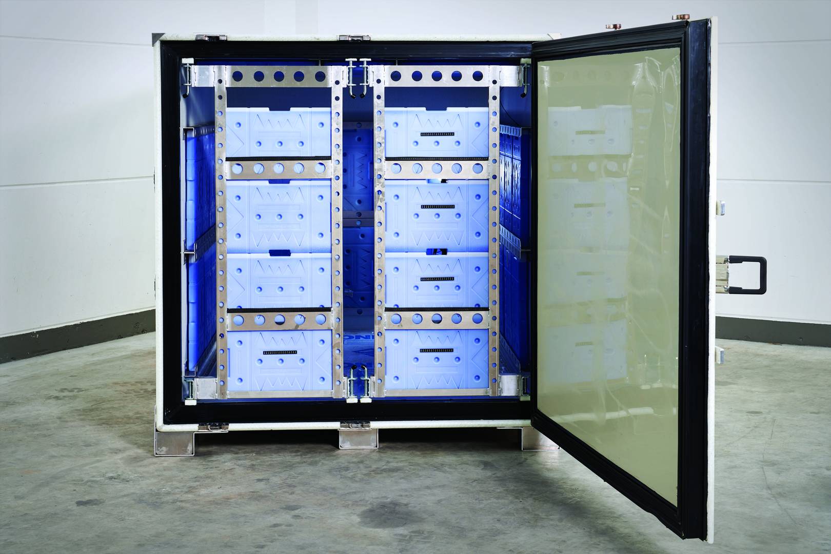 A cocoon shipping container with the door open, showing cooling gel packs in the internal frame.