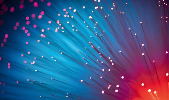 Abstract image of Red Color Illuminated Fiber Optics Selective Focus on Blue Background.