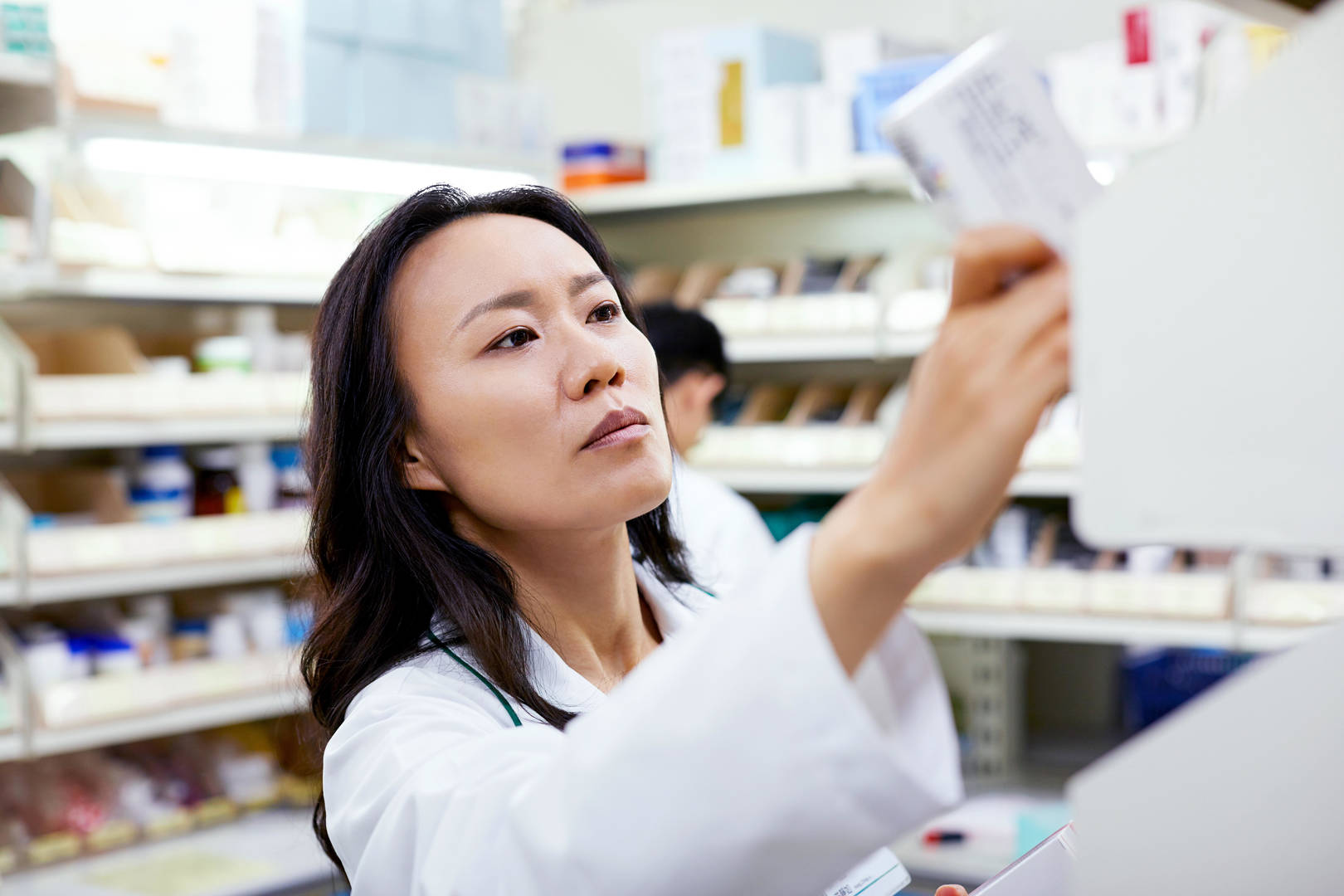 pharmacist female pulling product